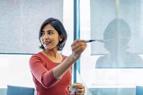 woman presenting on whiteboard