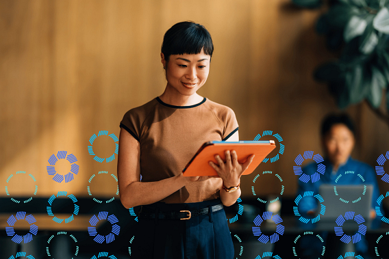 Woman smiling while looking at a tablet
